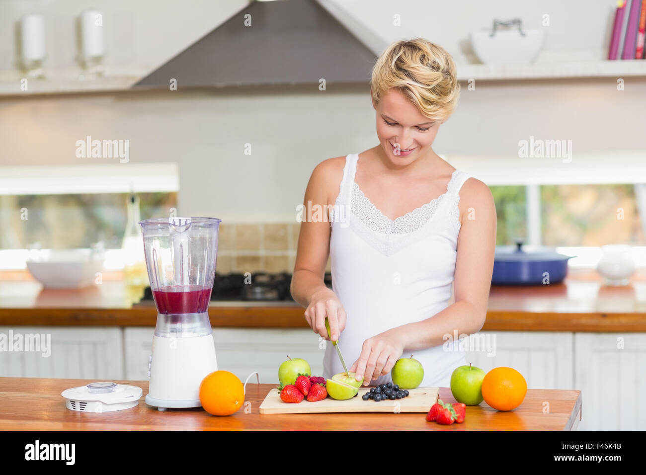 Pregnant woman preparing a fruit juice Stock Photo