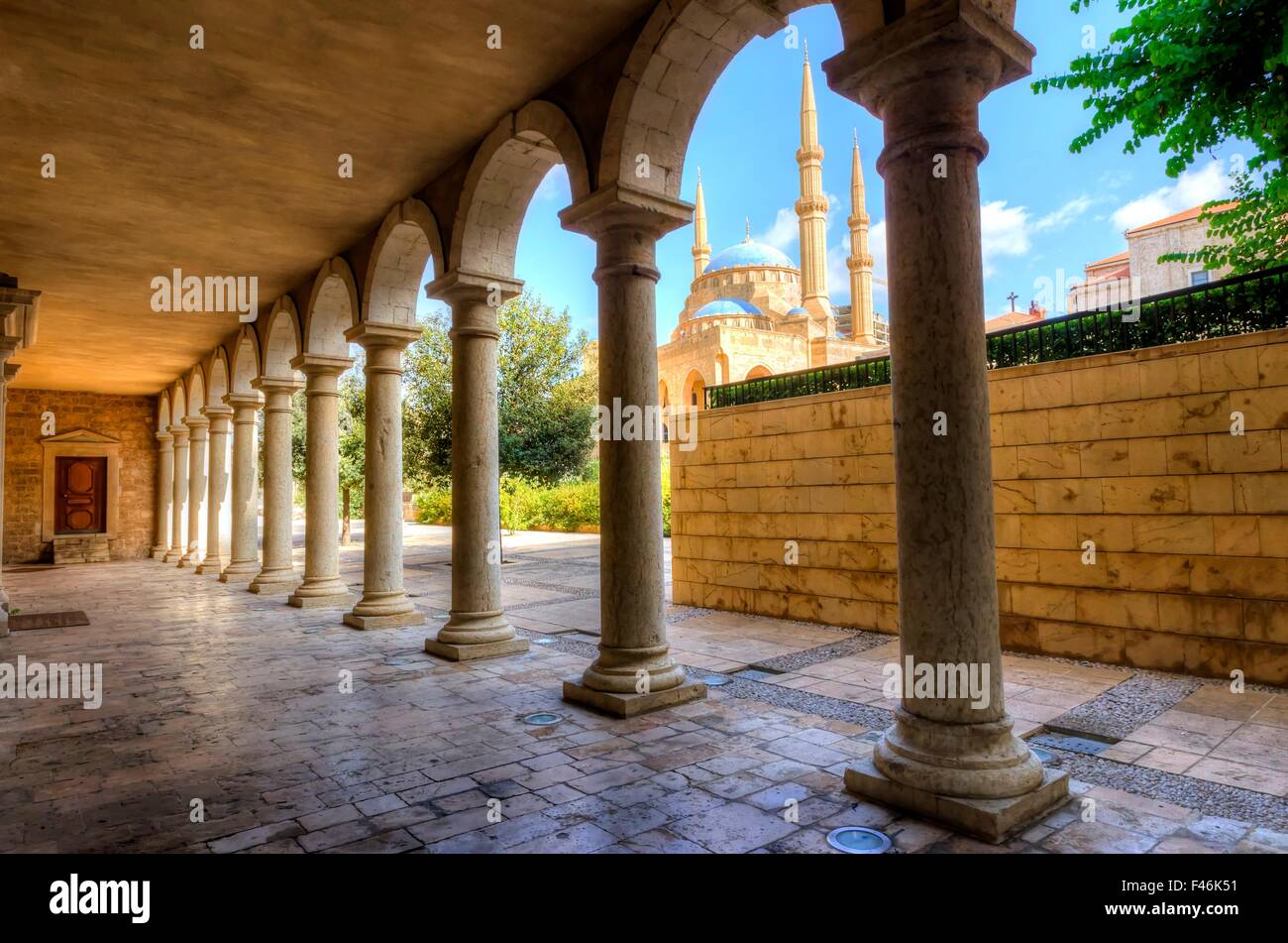 The Mohammad Al-Amin Mosque situated in Downtown Beirut, in Lebanon as viewed through the pillars of the Greek Orthodox church o Stock Photo