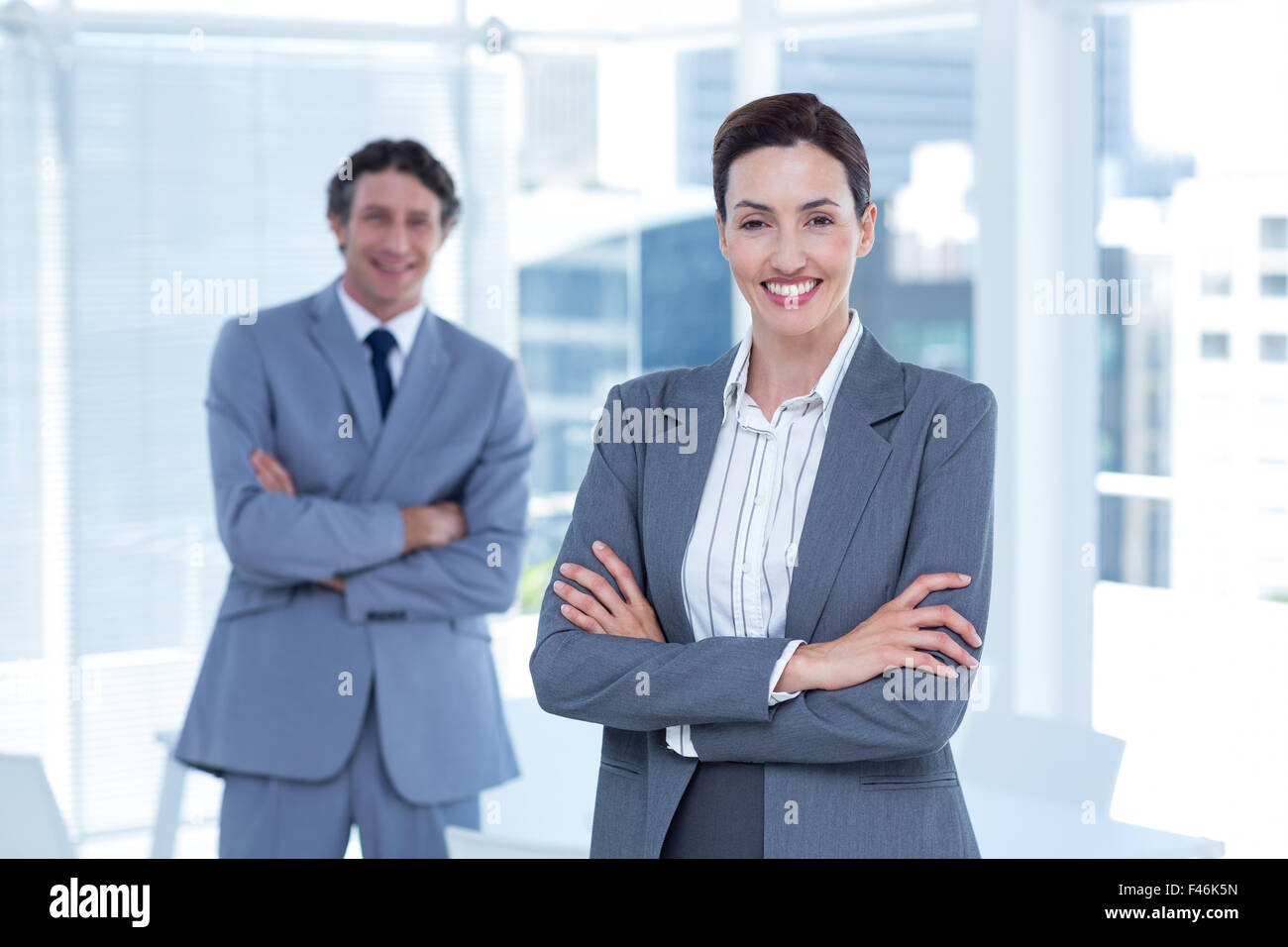 Smiling business people with arms crossed Stock Photo - Alamy