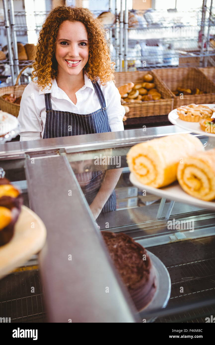 Pretty barista looking at camera behind counter Stock Photo