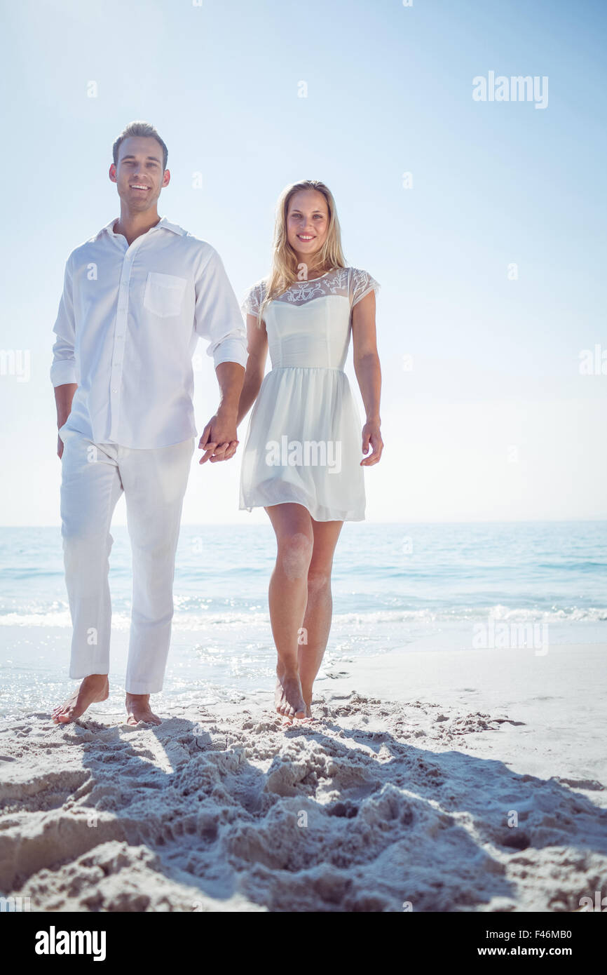 Couple holding hands and standing at beach Stock Photo - Alamy