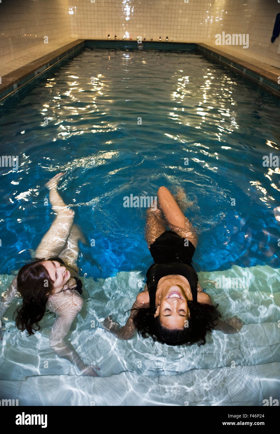 Two young women at public swimming baths, Stockholm, Sweden Stock Photo