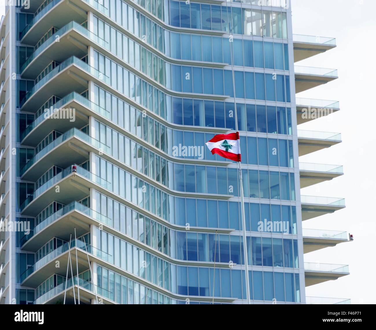 A view of the Beirut Marina tower in Zaitunay Bay in Lebanon and the lebanese flag. A very modern and new construction in Zaitun Stock Photo