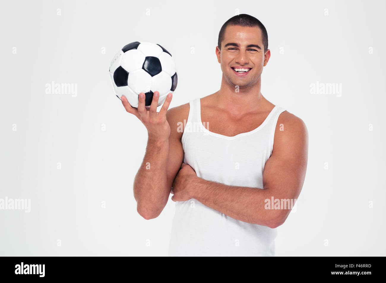 Portrait of a happy young man holding soccer ball isolated on a white ...