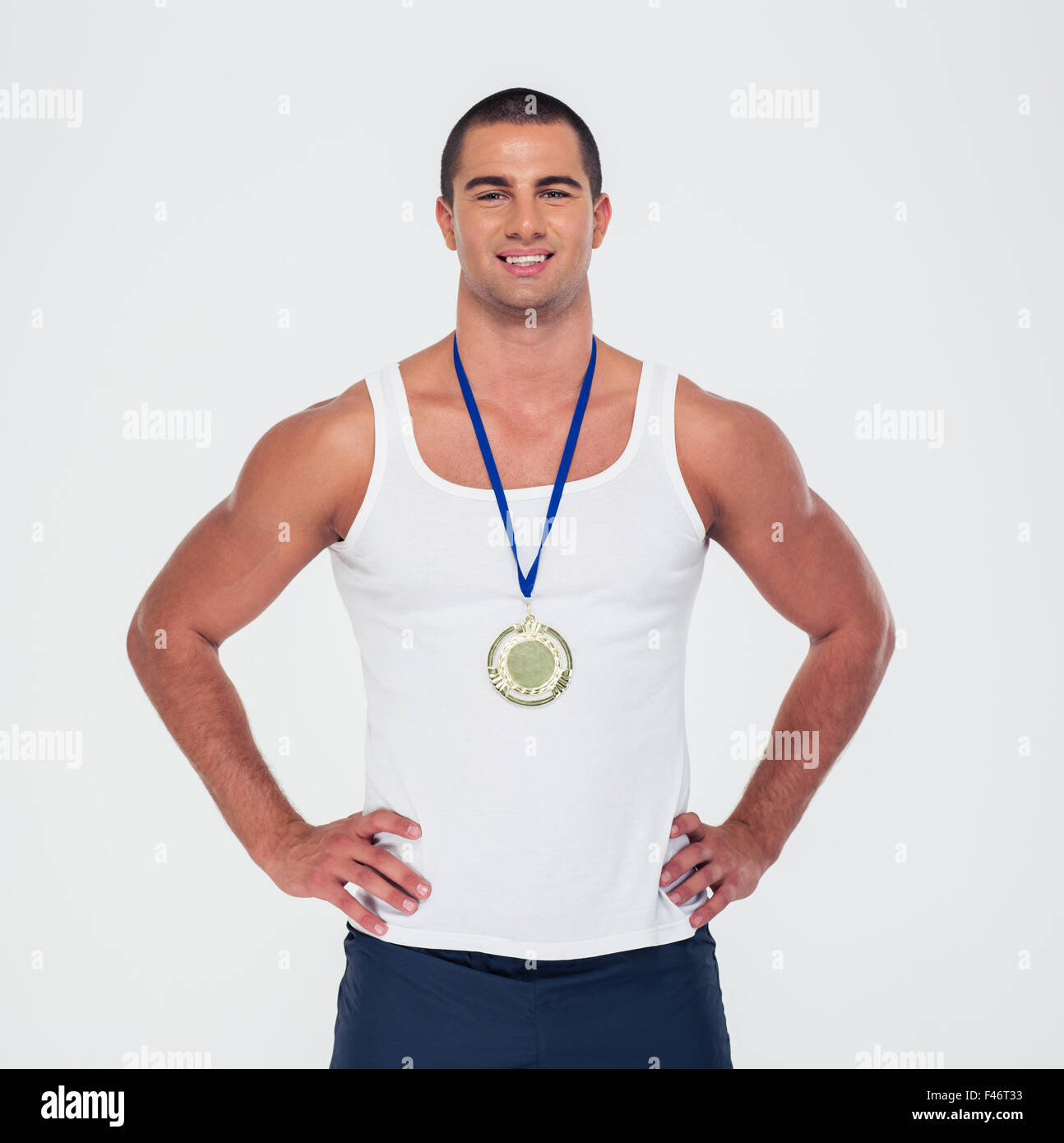 Portrait of a smiling sports man standing with medal isolated on a white background Stock Photo