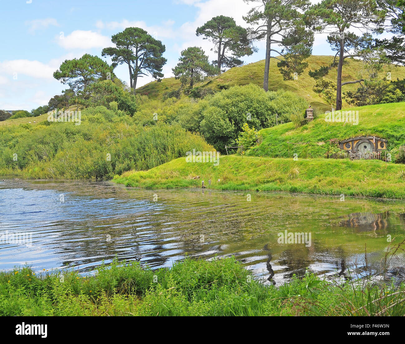 Hobbiton, Shire, New Zealand. Reflection of house on lake. Stock Photo