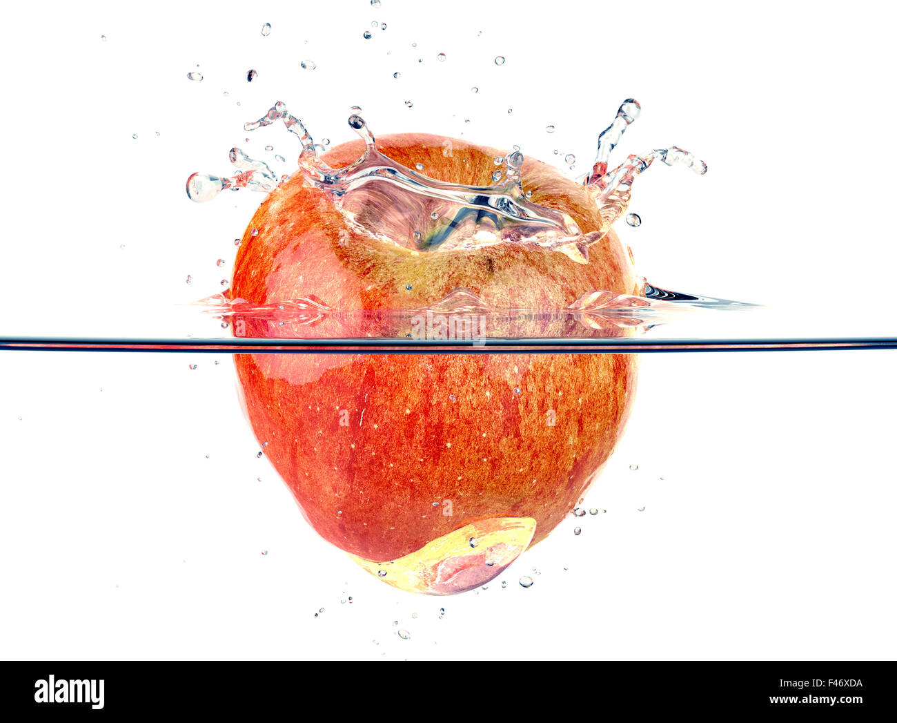 red apple faling and splashing into clear water Stock Photo