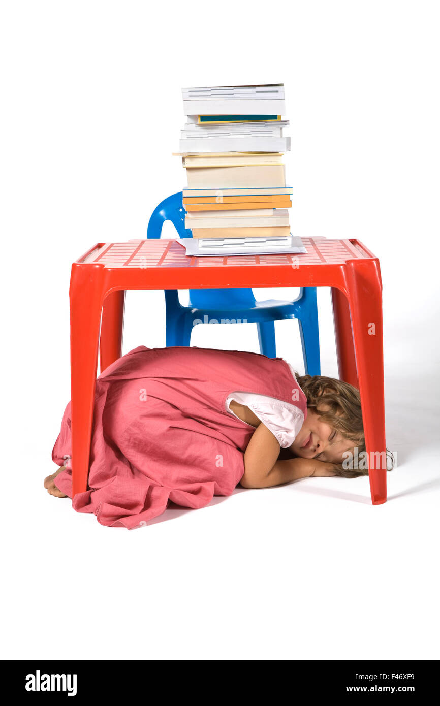 young girl sitted at the desk Stock Photo