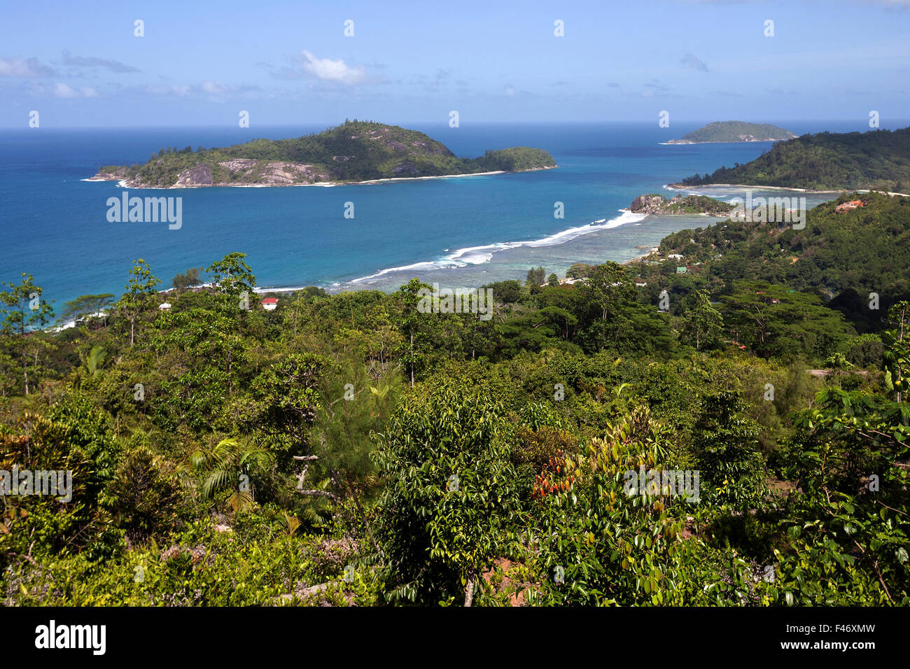 Views of coast and sea at Port Glaud, Ile Therese rear left, Mahe Island, Seychelles Stock Photo