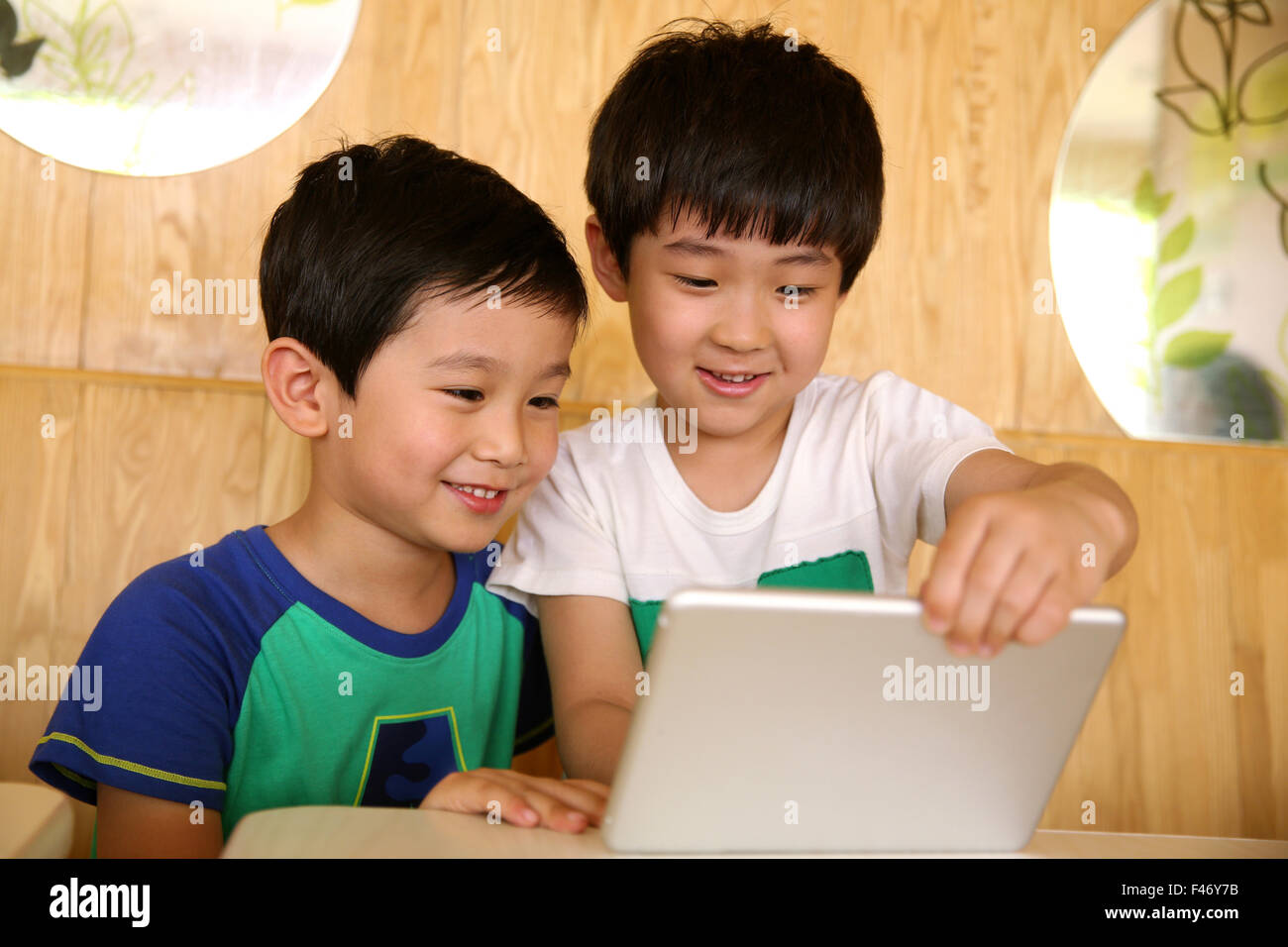 Two boys using digital tablet Stock Photo - Alamy