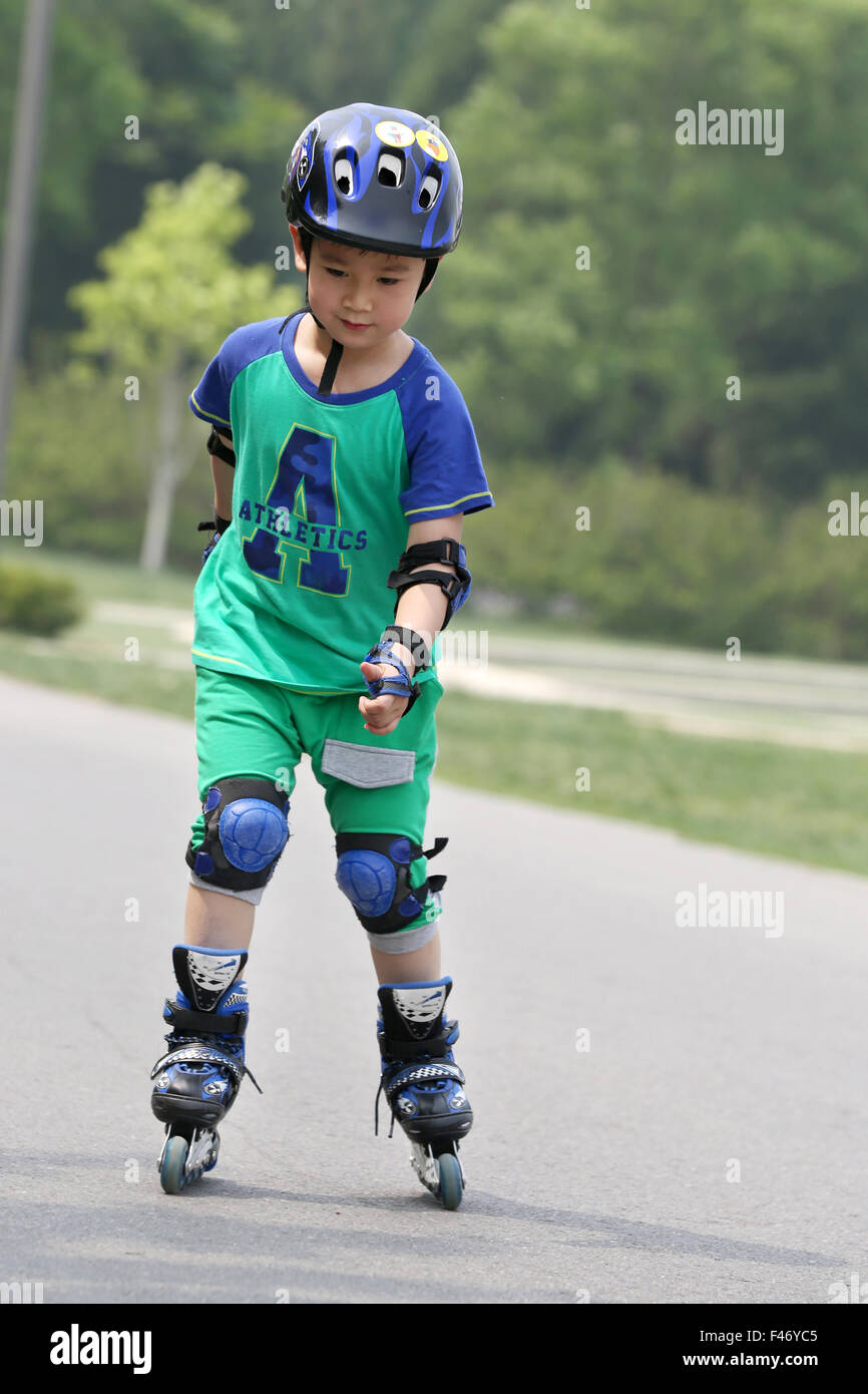 Boy inline skating outdoors Stock Photo Alamy