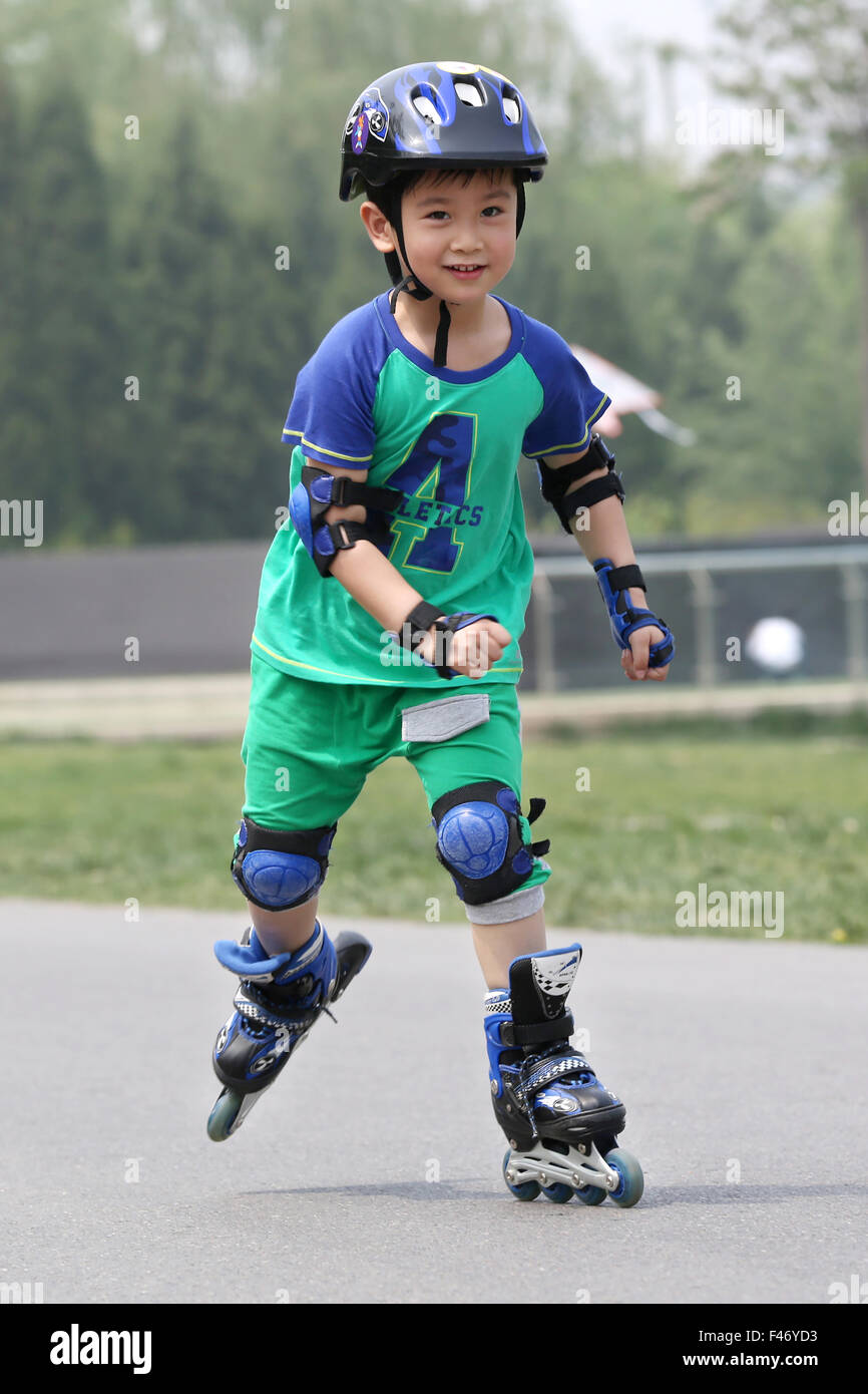 Boy inline skating outdoors Stock Photo Alamy