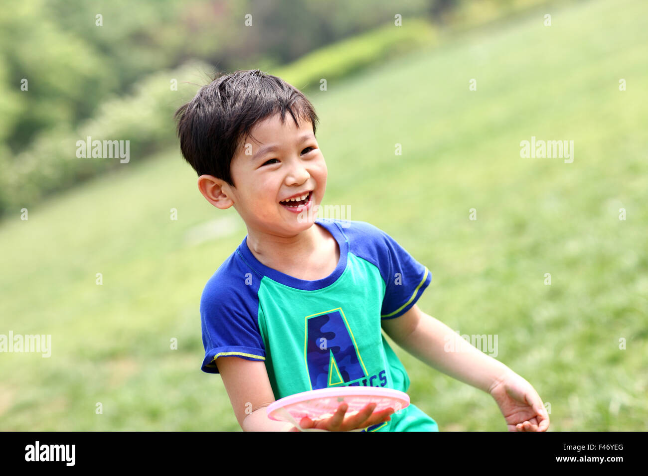 Portrait of boy playing outdoors Stock Photo - Alamy