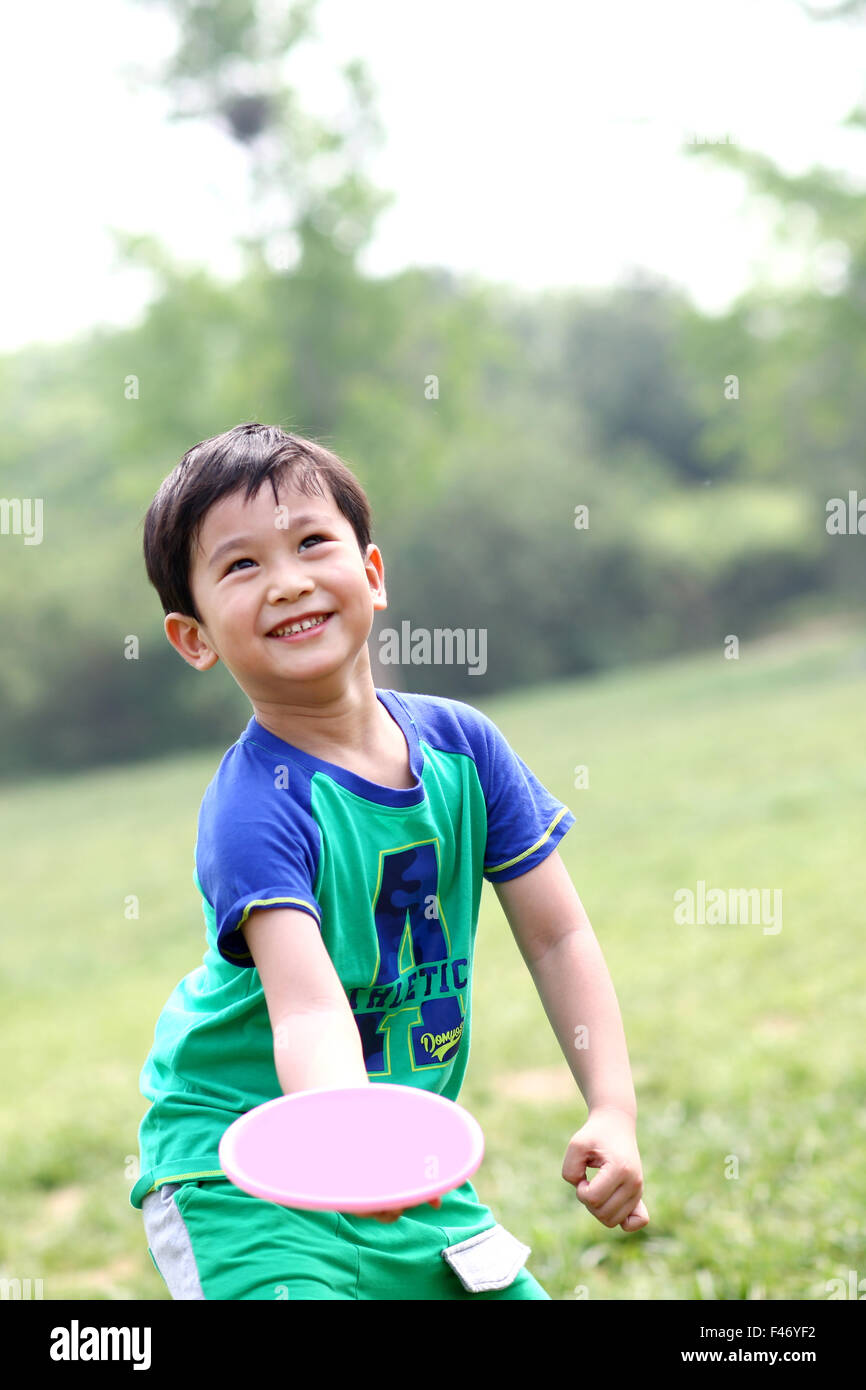Portrait of boy playing outdoors Stock Photo - Alamy