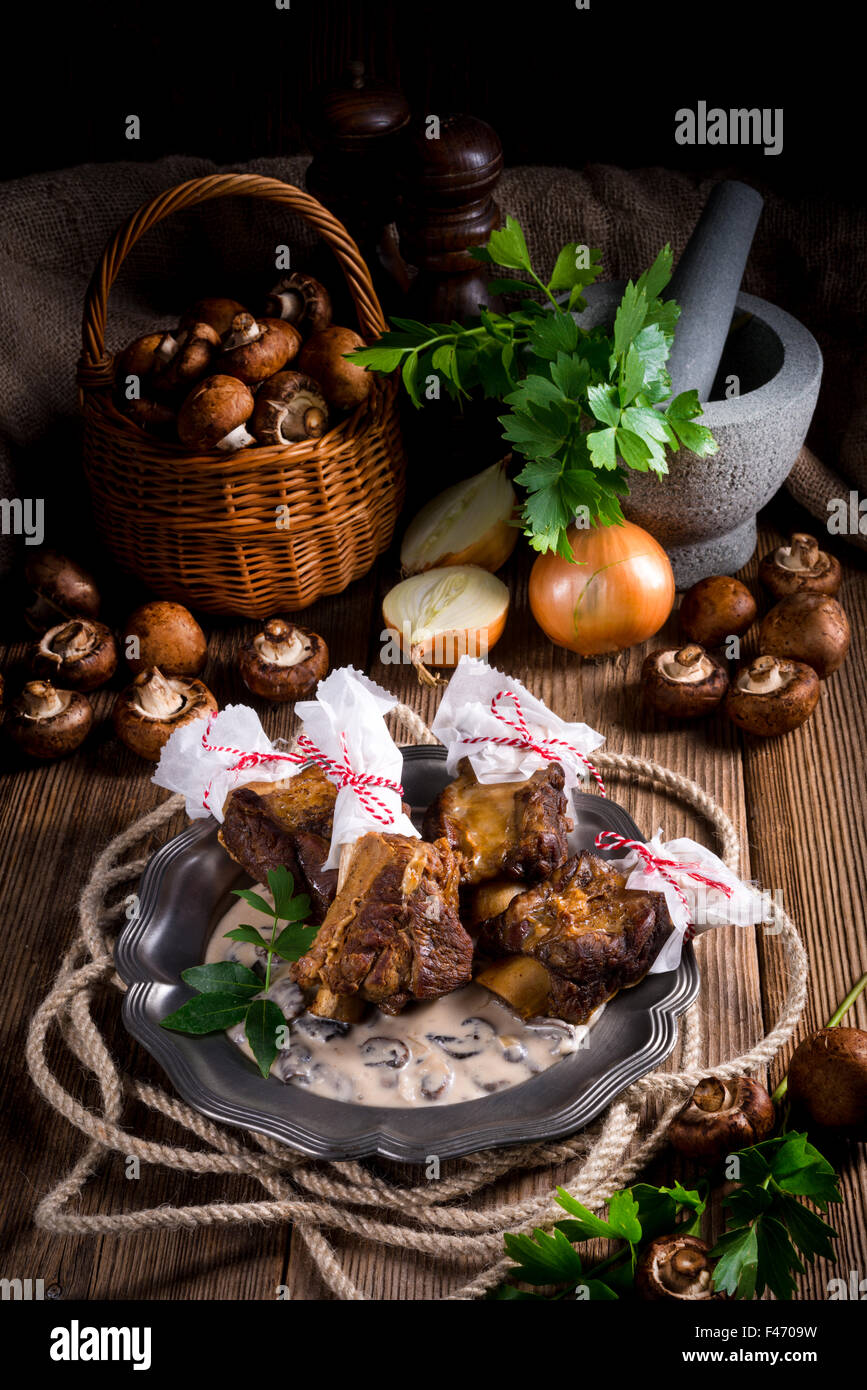Grilled rinderrippchen with mushroom sauce Stock Photo - Alamy