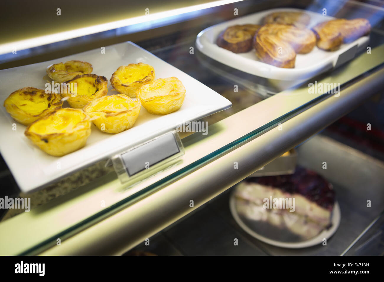 Cakes in display case Stock Photo Alamy