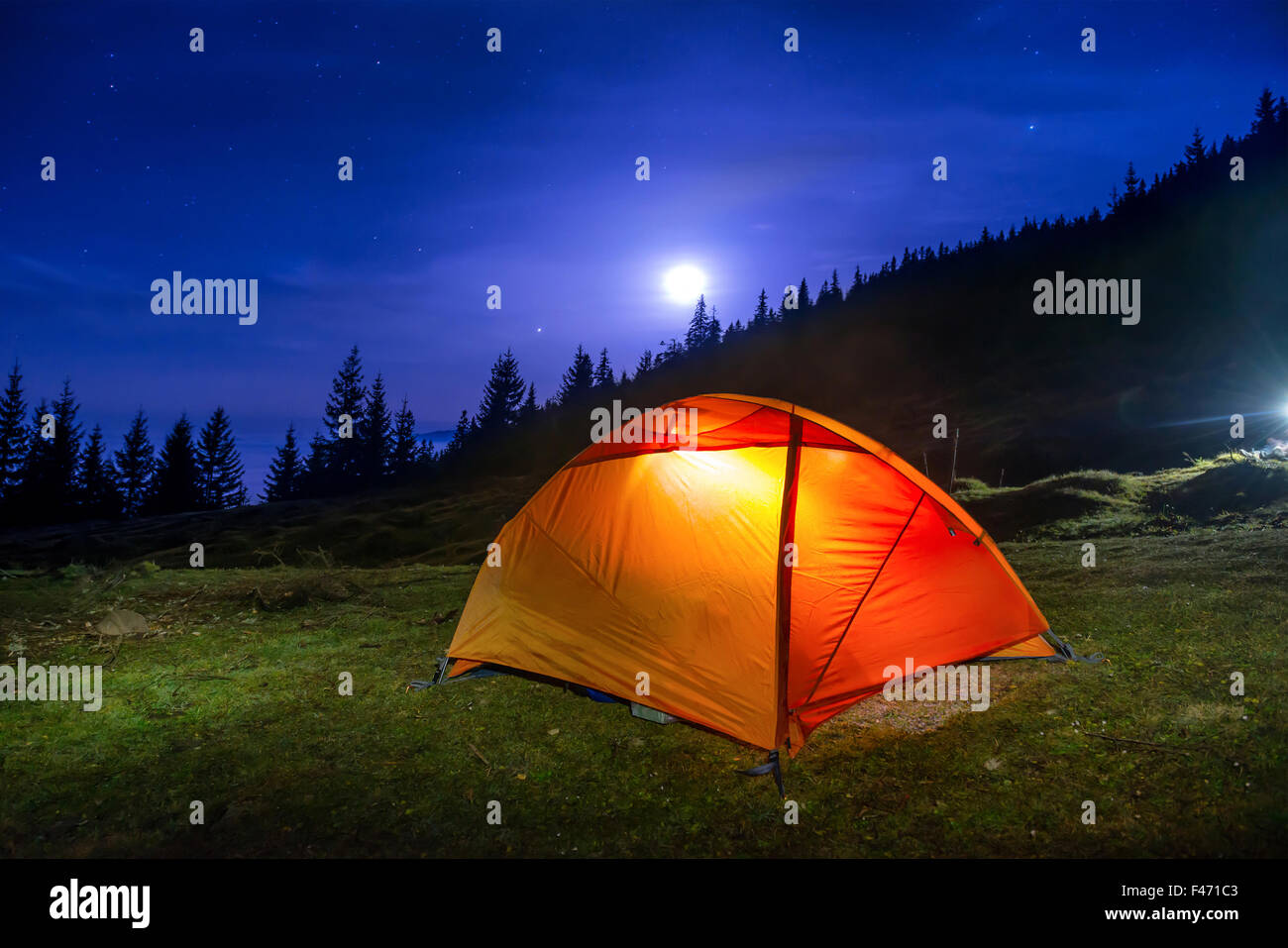 Illuminated orange camping tent Stock Photo Alamy