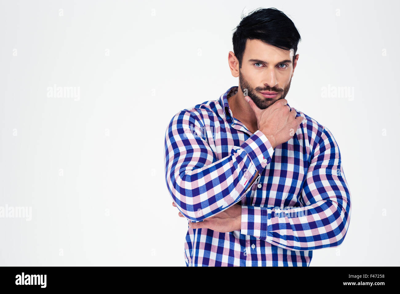Portrait of a serious man looking at camera isolated on a white ...
