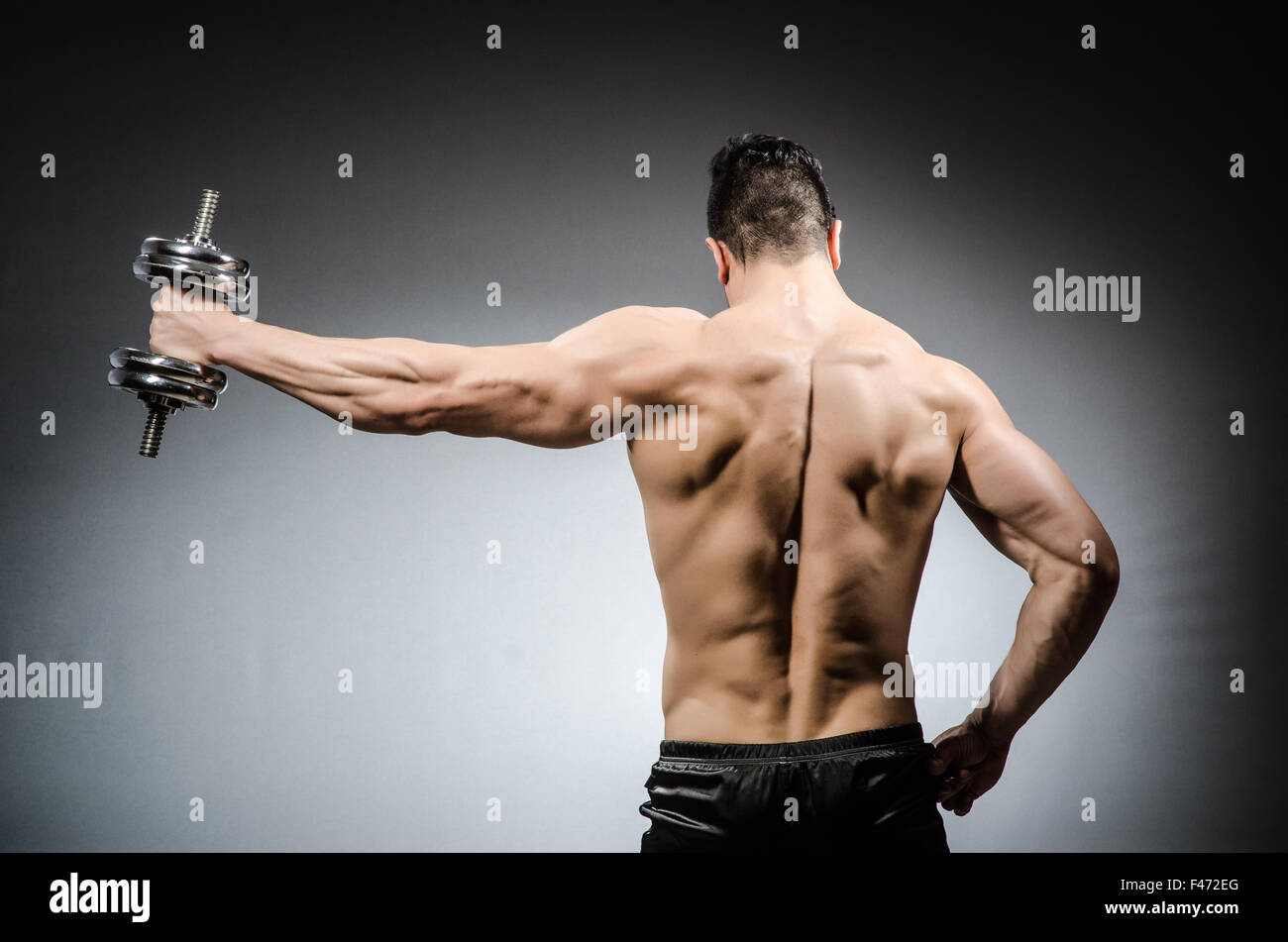 Muscular ripped bodybuilder with dumbbells Stock Photo - Alamy