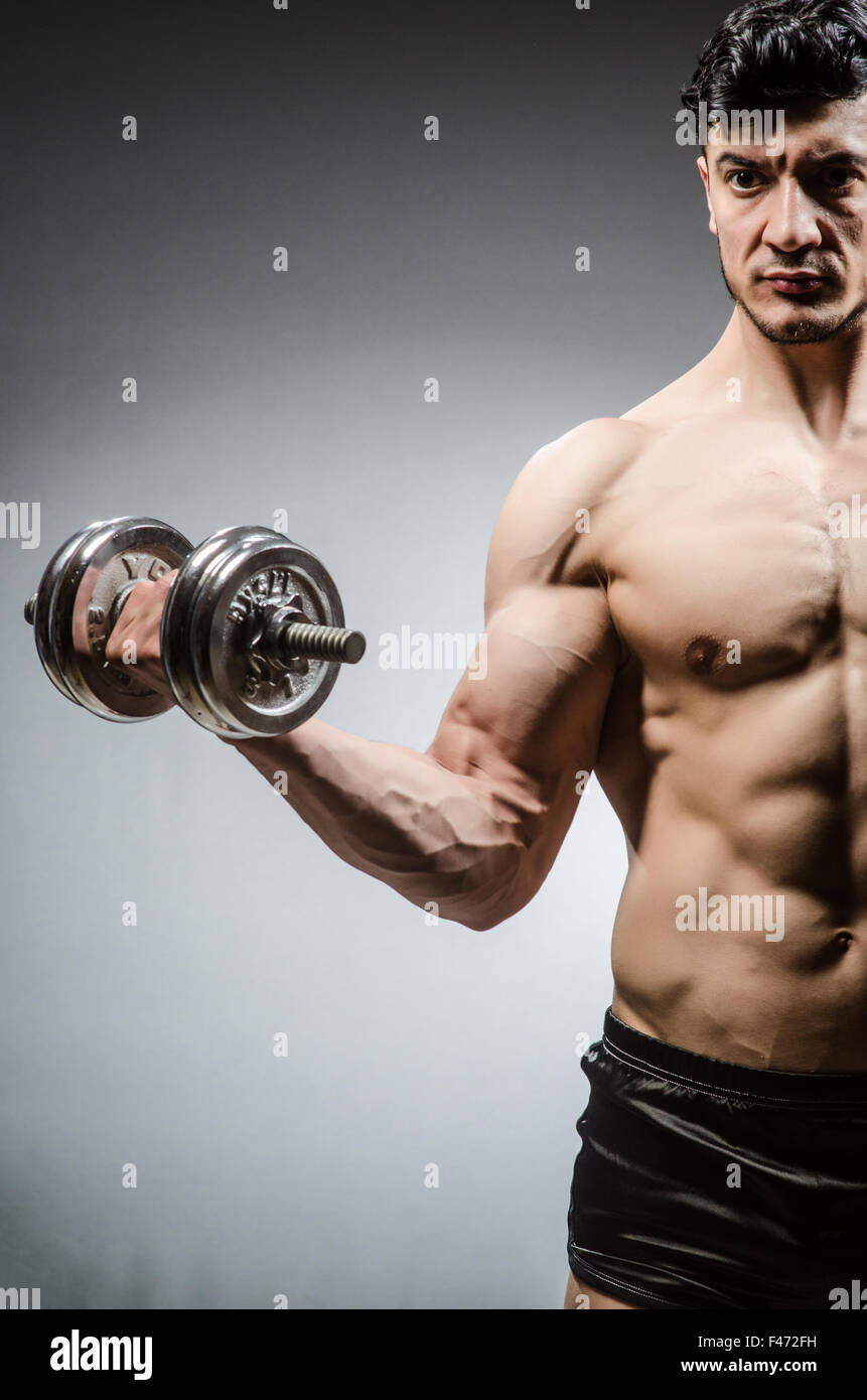 Muscular ripped bodybuilder with dumbbells Stock Photo - Alamy