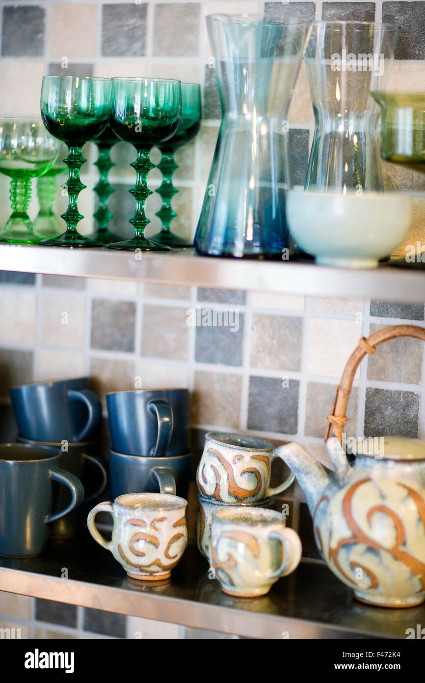 Glasses and cups on a kitchen shelf Stock Photo - Alamy