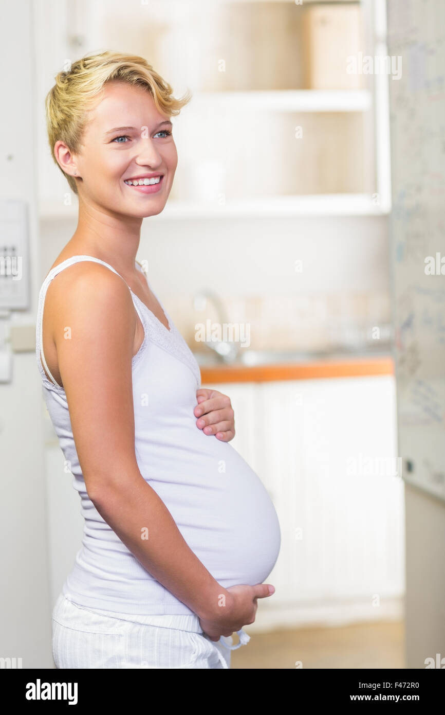 Pregnant woman cuddling her stomach Stock Photo Alamy