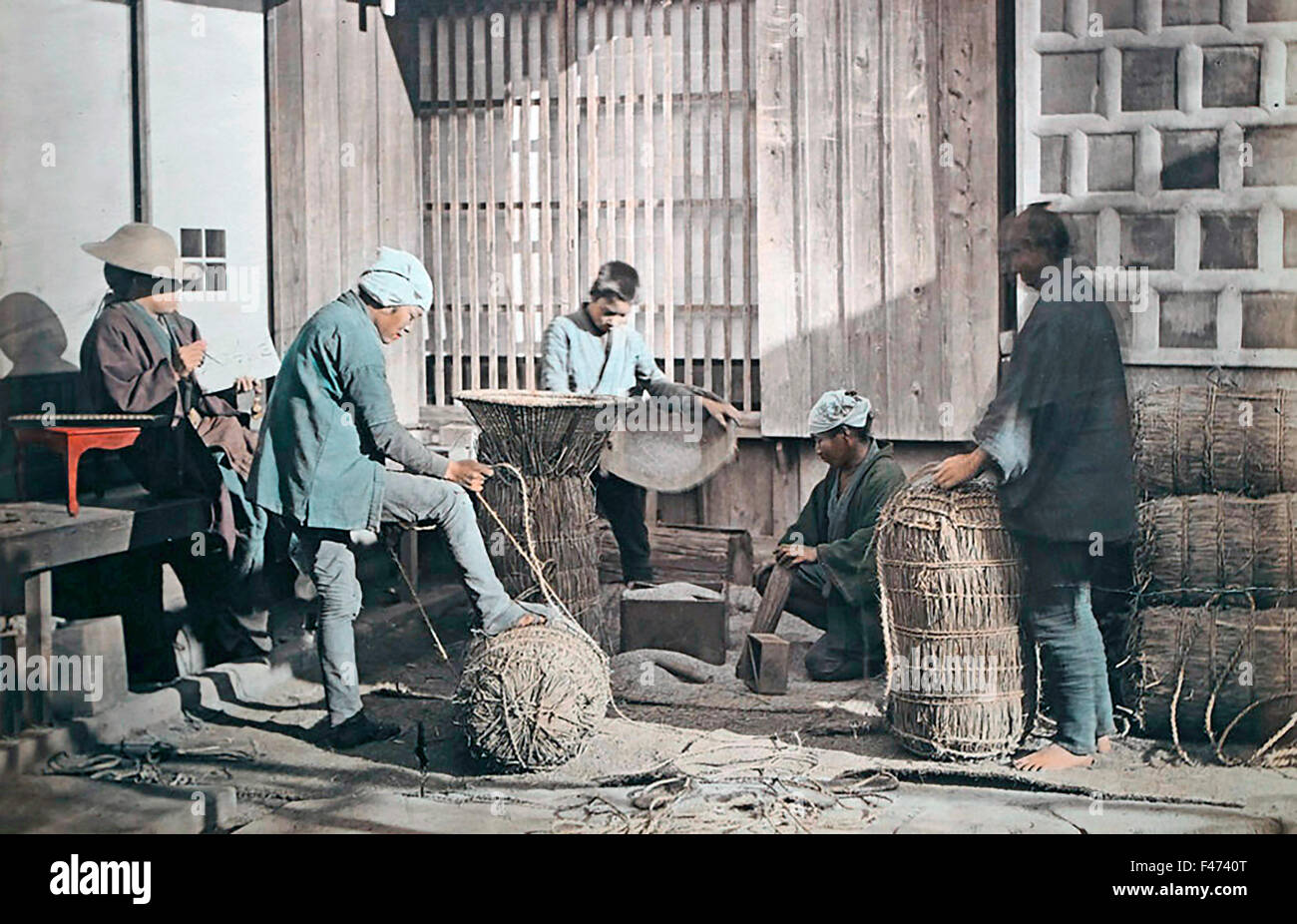 Farmers producing rice bundles, Japan Stock Photo