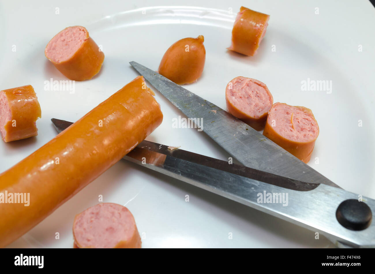 Frankfurter sausage cut with scissors Stock Photo
