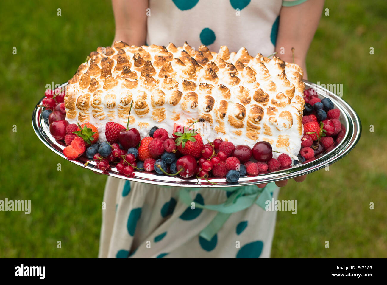 Portrait of a girl holding a cake in the summer, Sweden. Stock Photo