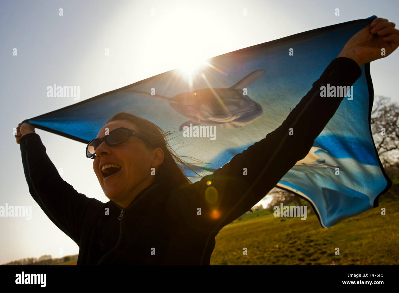 A woman holding a cloth in the wind, Sweden. Stock Photo