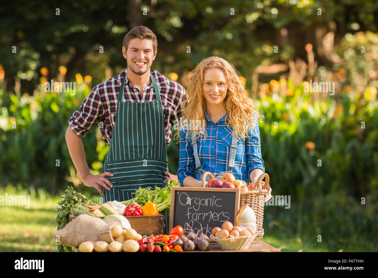 Couple selling organic vegetables at market Stock Photo - Alamy