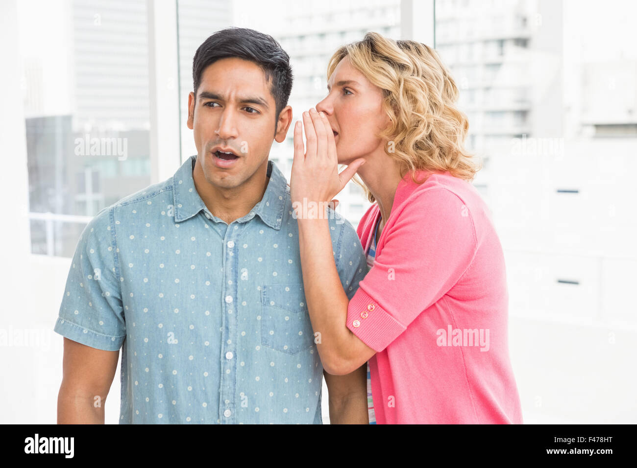 Colleagues whispering Stock Photo