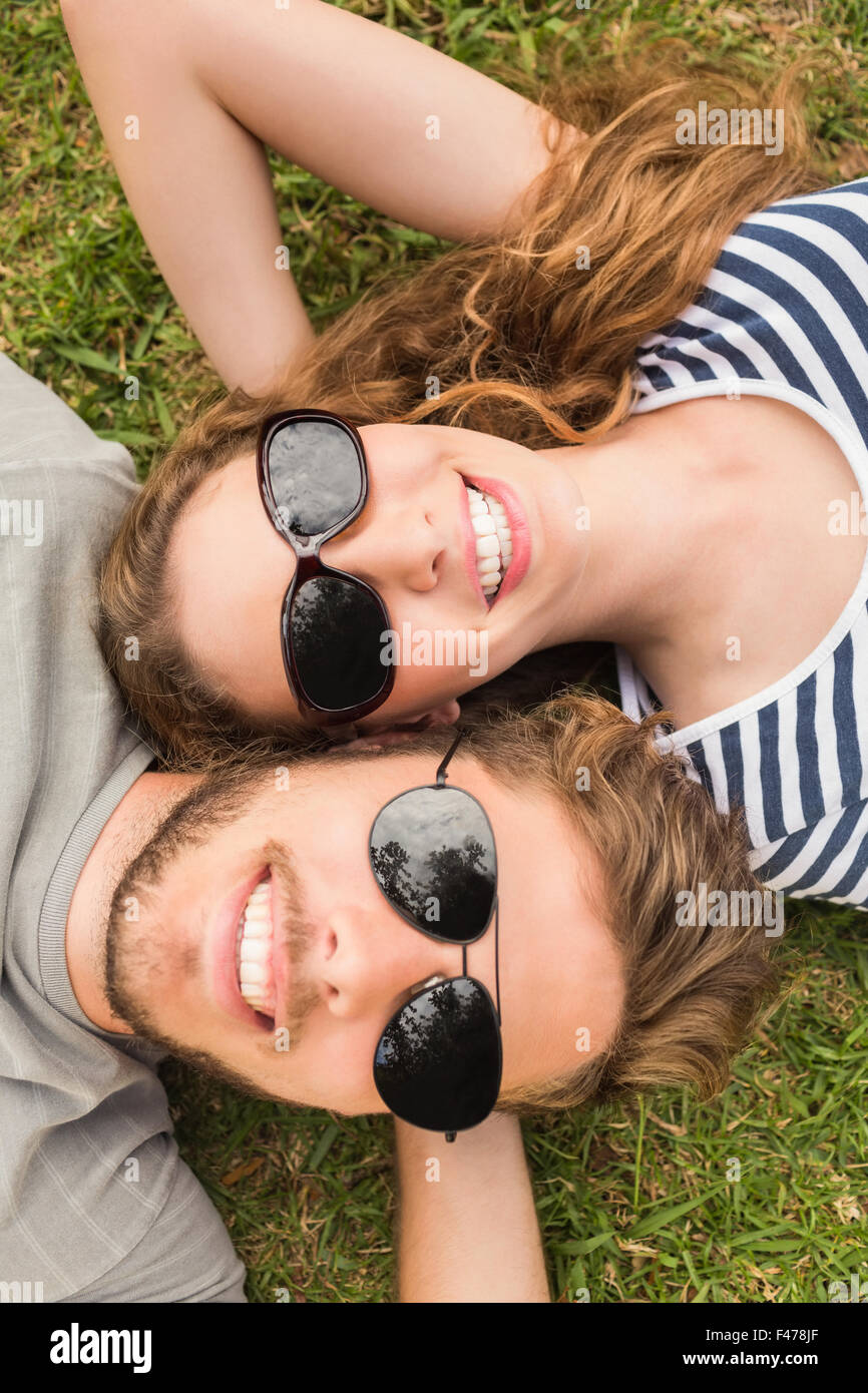 Cute couple relaxing in the grass in the park Stock Photo - Alamy