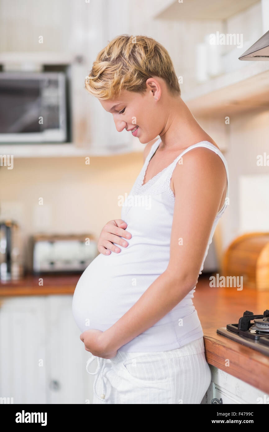 Pregnant woman cuddling her stomach Stock Photo Alamy