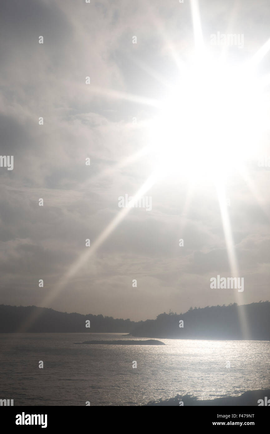 A hazy sunlight at dawn by the sea, Sweden Stock Photo Alamy