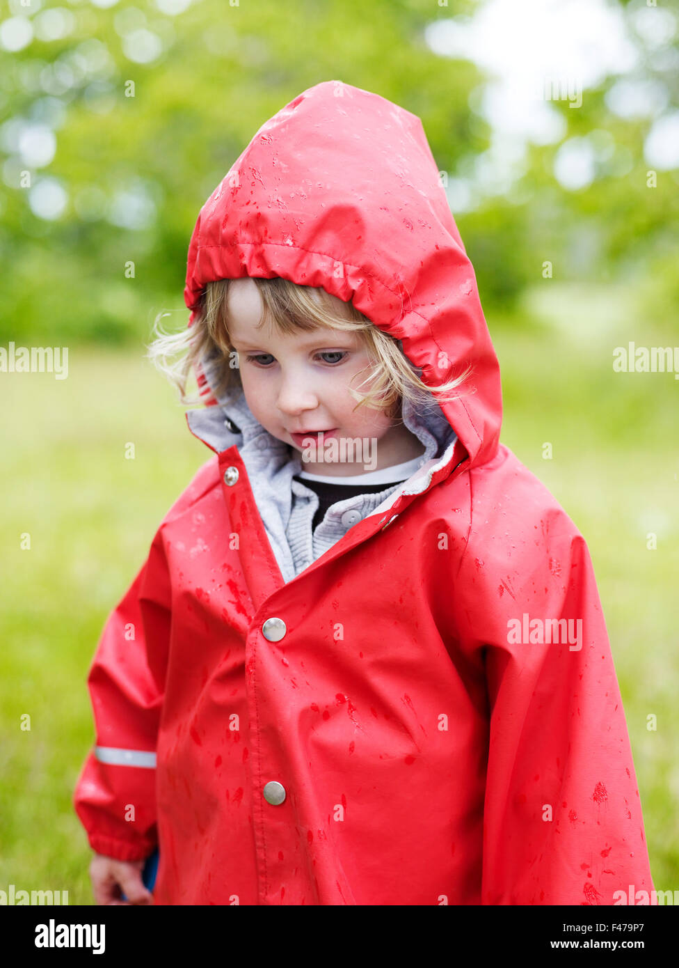 A girl in a red raincoat, Sweden Stock Photo - Alamy