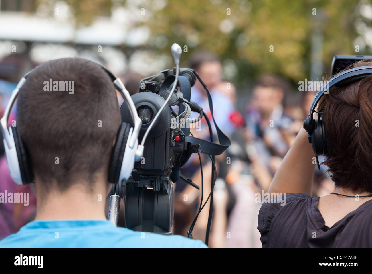 Filming an event with a video camera. Stock Photo