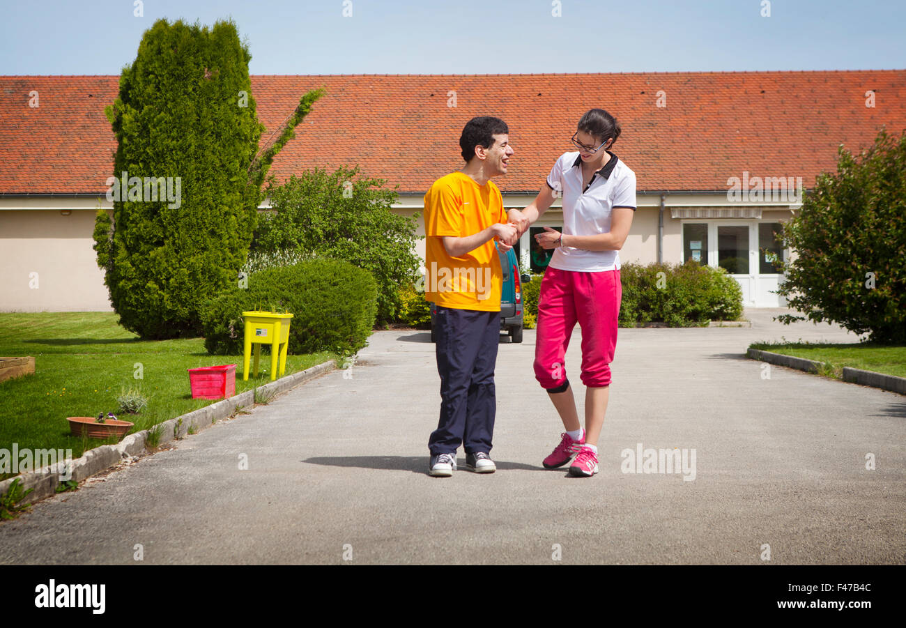 SPORTS INSTRUCTOR WITH DISABLED MAN Stock Photo