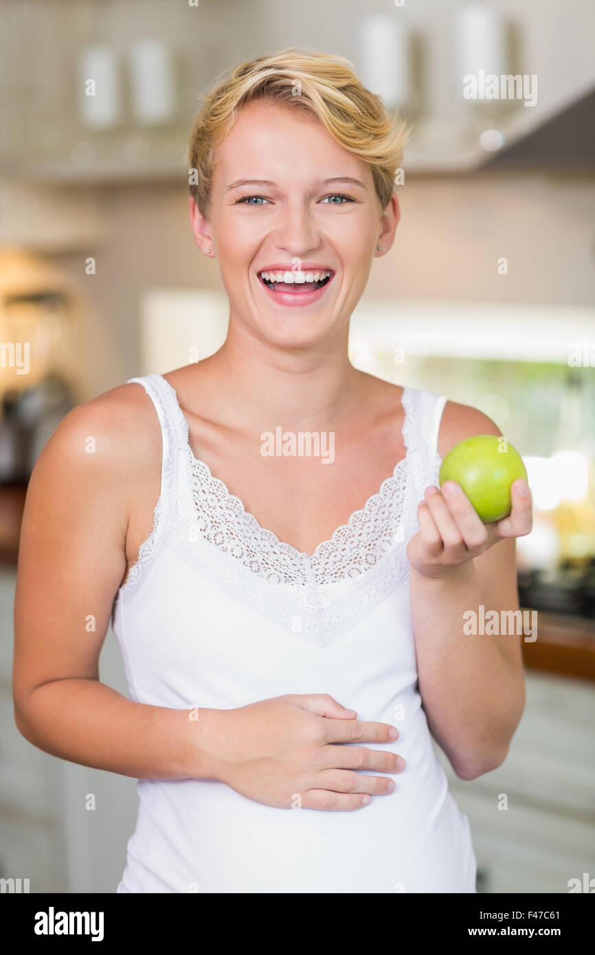 Pregnant woman eating a green apple Stock Photo Alamy
