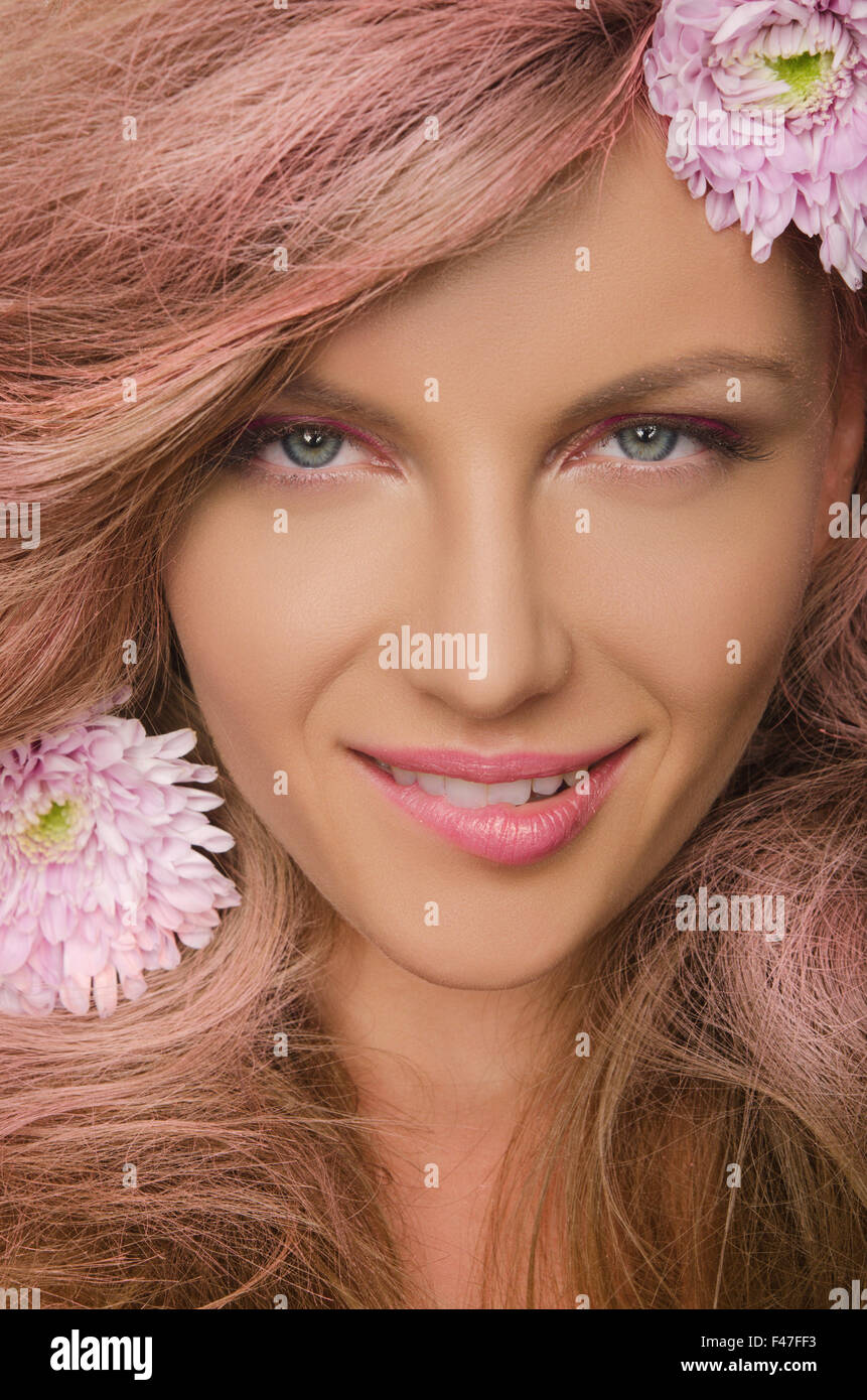 young woman with pink hair and flowers Stock Photo