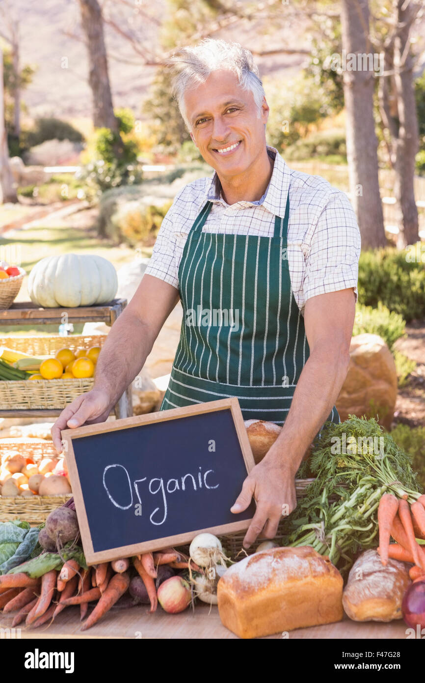 Smiling farmer holding a basket of vegetables Stock Photo - Alamy