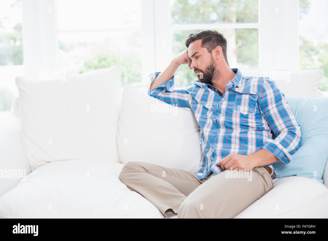 Unhappy man suffering from migraine Stock Photo