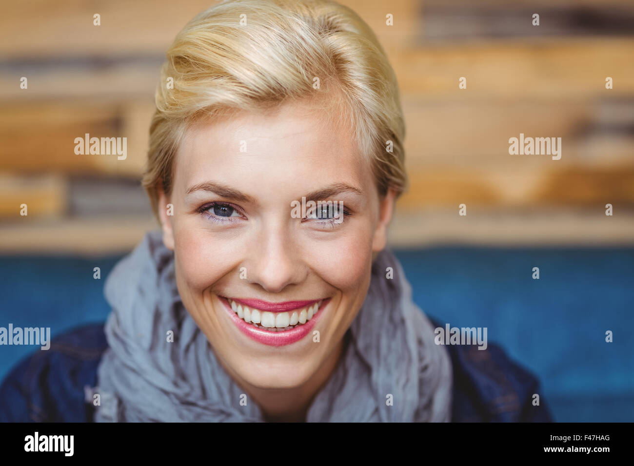Pretty blonde smiling at the camera Stock Photo - Alamy