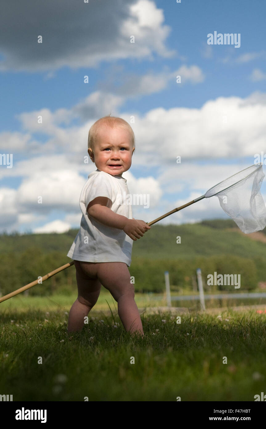 A boy playing with butterfly-net, Sweden. Stock Photo
