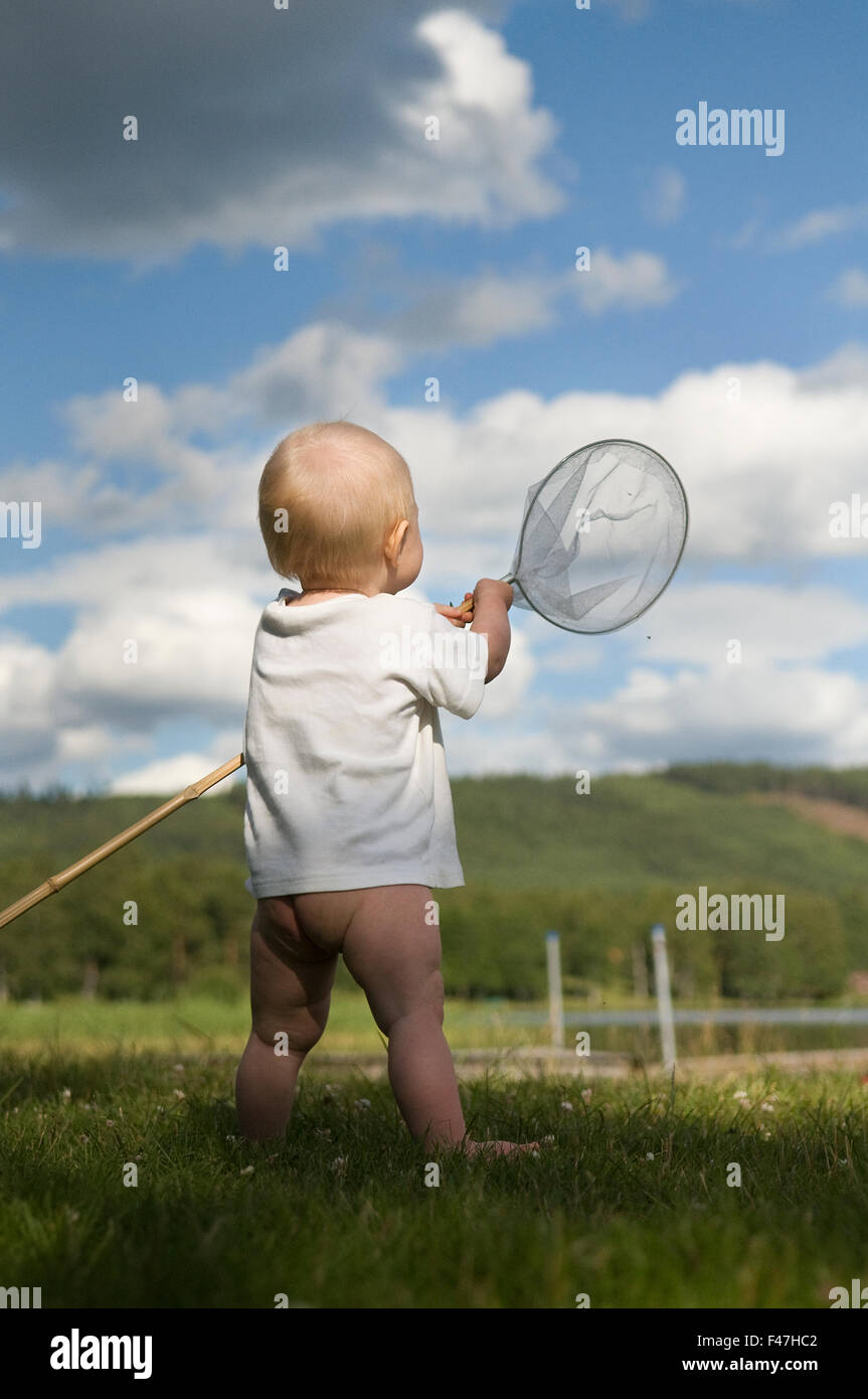 A boy playing with butterfly-net, Sweden. Stock Photo