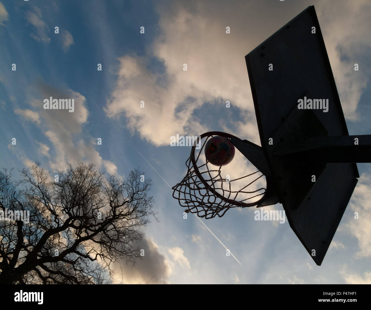 ball going into basketball / netball hoop Stock Photo