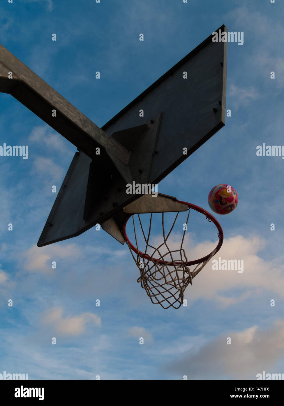 ball going into basketball / netball hoop Stock Photo