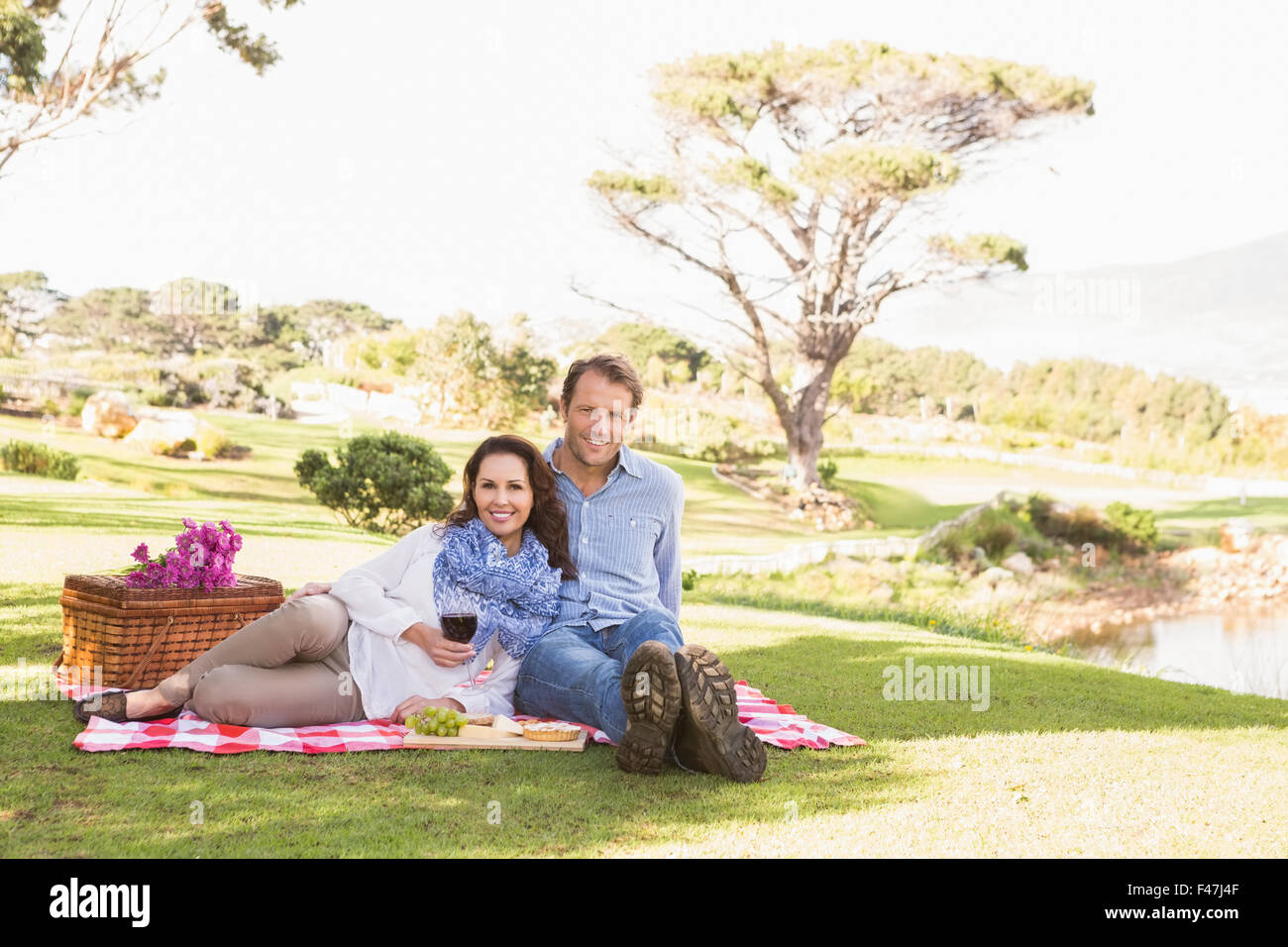 Cute couple drinking wine in a park Stock Photo - Alamy