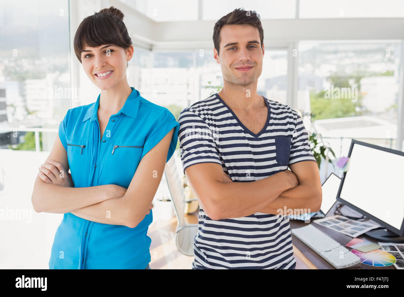 Casual business team smiling at camera with arms crossed Stock Photo ...
