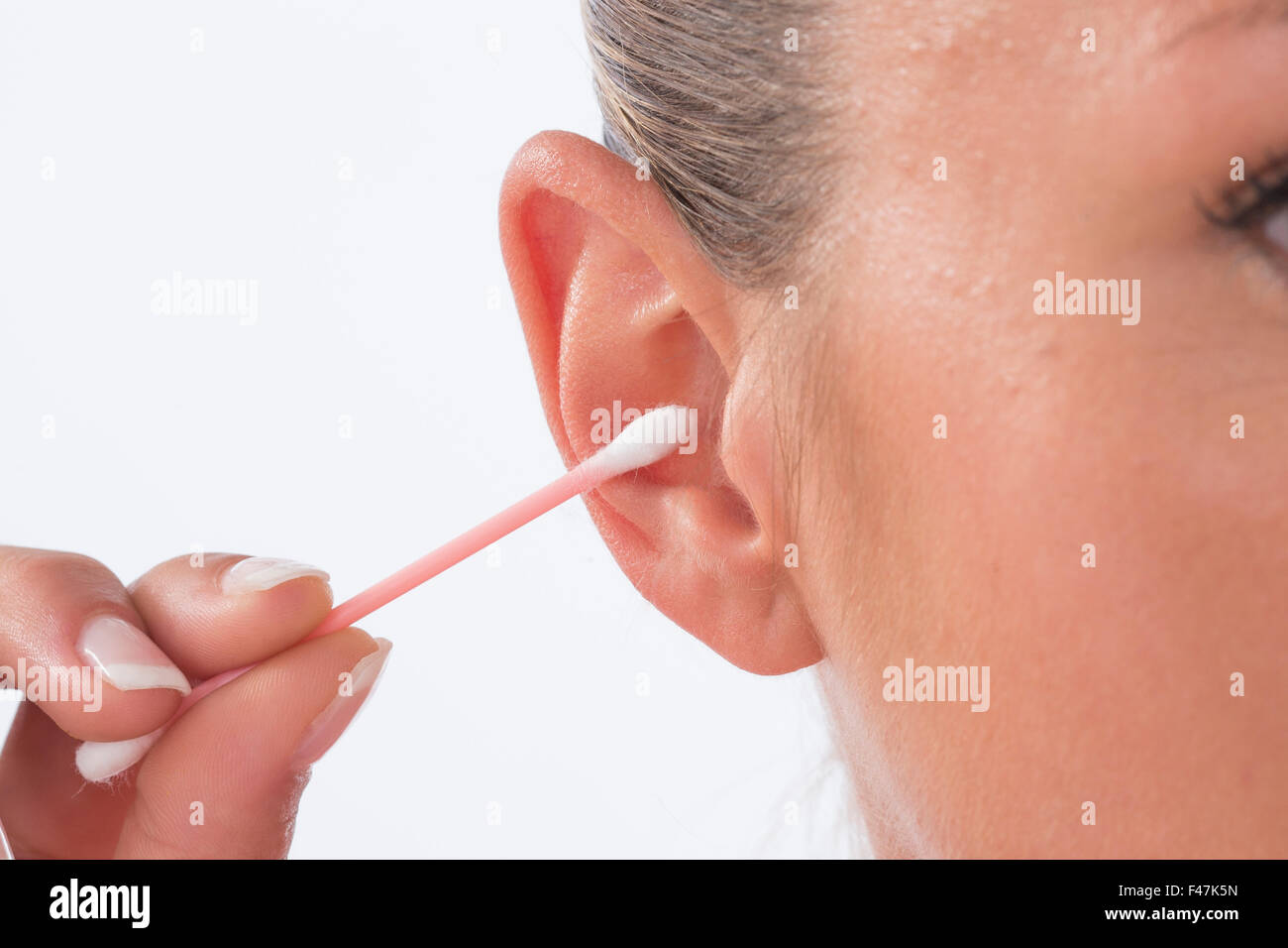 WOMAN CLEANING EAR Stock Photo